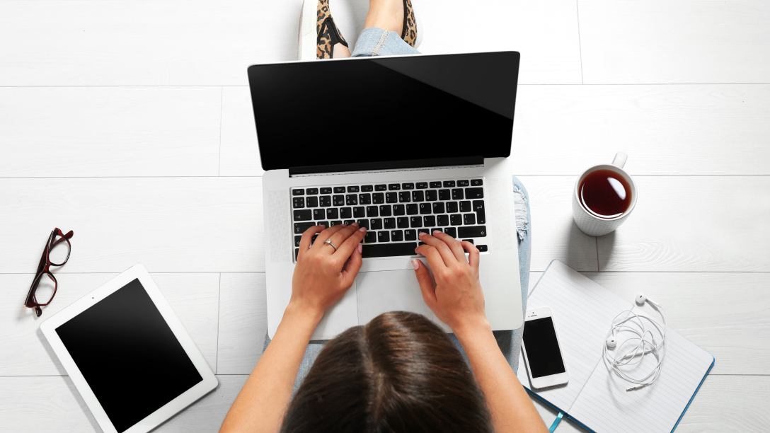 woman sitting with laptop on lap